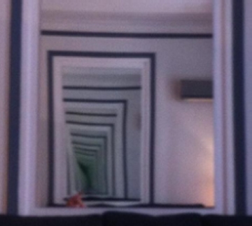 Two grayscale mirrors reflecting each other ad infinitum